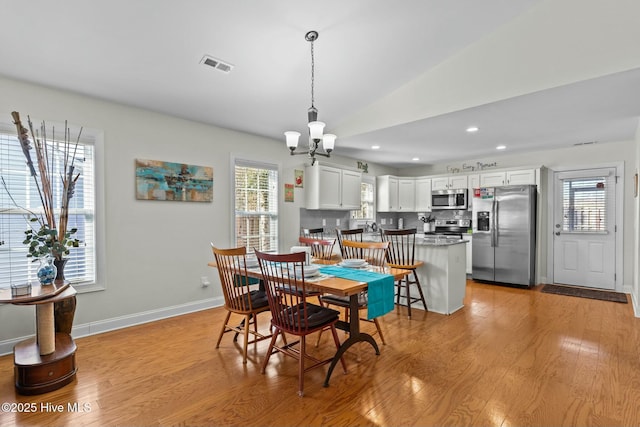 dining space featuring baseboards, visible vents, light wood-type flooring, a notable chandelier, and recessed lighting