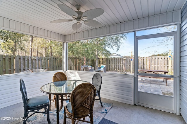 sunroom featuring a ceiling fan and a wealth of natural light