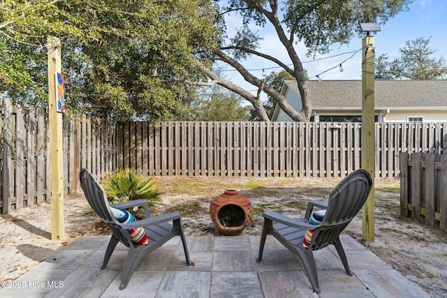 view of patio with an outdoor fire pit and a fenced backyard