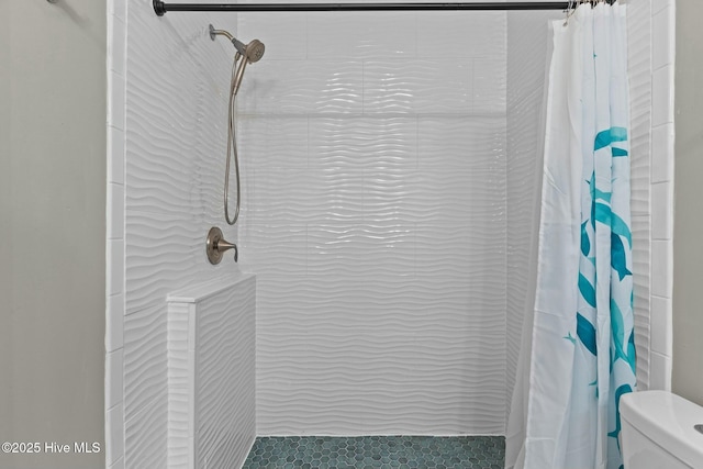 full bathroom with toilet and tiled shower