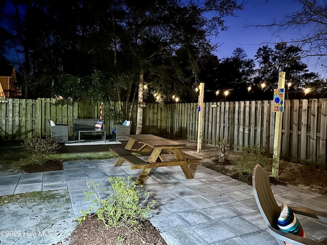 view of community featuring a fenced backyard and a patio