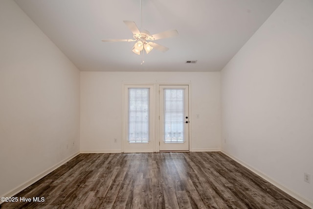 doorway to outside featuring baseboards, visible vents, ceiling fan, and dark wood-style flooring