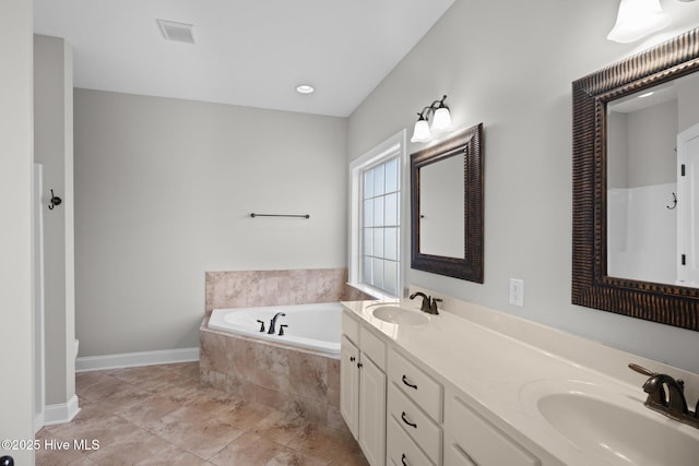 bathroom featuring tiled tub and vanity