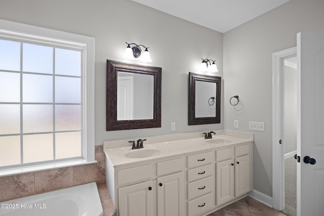 bathroom with vanity, a bathing tub, and tile patterned floors