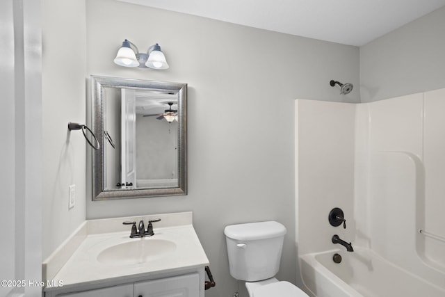 full bathroom featuring toilet, vanity, and washtub / shower combination