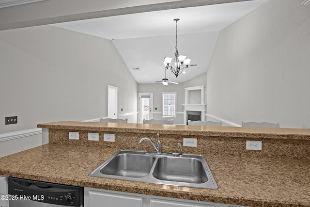 kitchen with pendant lighting, dishwasher, vaulted ceiling, and sink