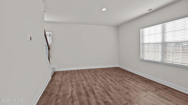 spare room featuring wood-type flooring