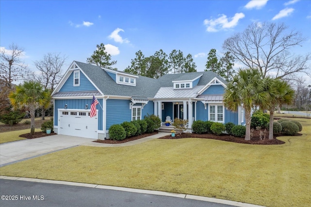 craftsman house featuring a garage and a front lawn