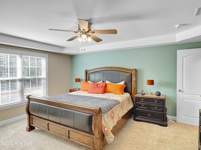 bedroom with visible vents, ceiling fan, light colored carpet, and baseboards