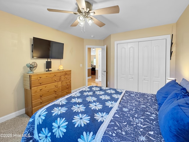 bedroom with a closet, ceiling fan, and baseboards