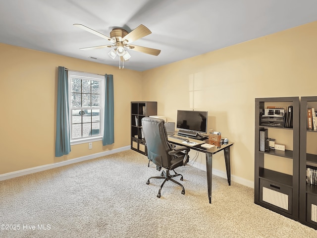 home office with light carpet, a ceiling fan, visible vents, and baseboards