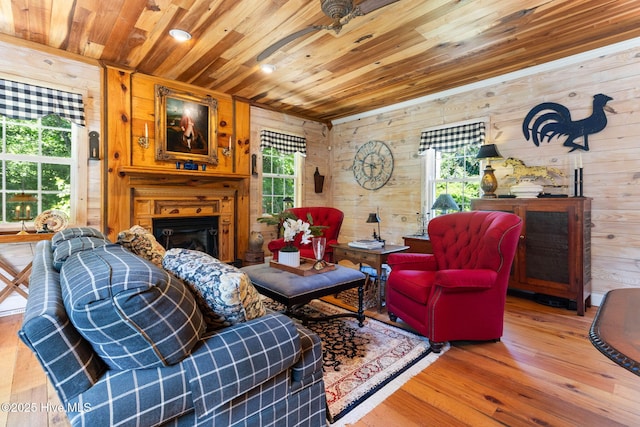 121 Dolphin Ln, Sneads Ferry, NC 28460 - living area with wood ceiling, wooden walls, wood finished floors, a glass covered fireplace, and ceiling fan
