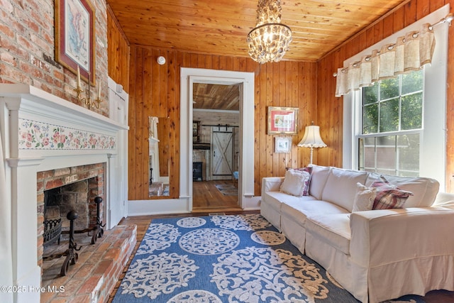 121 Dolphin Ln, Sneads Ferry, NC 28460 - living area featuring wooden walls, a chandelier, a brick fireplace, and wood ceiling