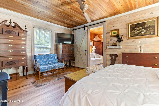 121 Dolphin Ln, Sneads Ferry, NC 28460 - bedroom featuring a barn door, wood walls, wood finished floors, wood ceiling, and ornamental molding