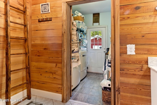 121 Dolphin Ln, Sneads Ferry, NC 28460 - laundry area with washer / clothes dryer, wood walls, tile patterned flooring, and baseboards