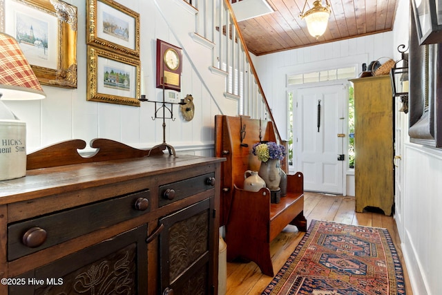 121 Dolphin Ln, Sneads Ferry, NC 28460 - foyer entrance with wood ceiling, light wood finished floors, stairway, a decorative wall, and wood walls