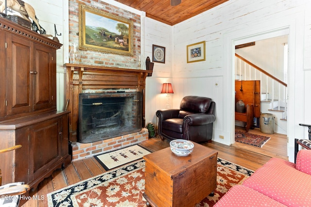 121 Dolphin Ln, Sneads Ferry, NC 28460 - living room featuring wood finished floors, a fireplace, stairs, and wooden ceiling