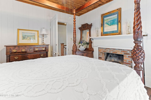 121 Dolphin Ln, Sneads Ferry, NC 28460 - bedroom featuring wooden ceiling with exposed beams, a brick fireplace, and wooden walls