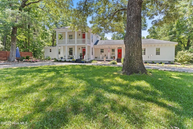 121 Dolphin Ln, Sneads Ferry, NC 28460 - neoclassical home featuring a balcony, a front yard, and covered porch