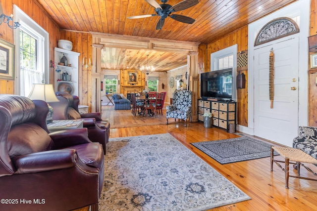 121 Dolphin Ln, Sneads Ferry, NC 28460 - living room with wooden walls, plenty of natural light, a chandelier, wooden ceiling, and ceiling fan