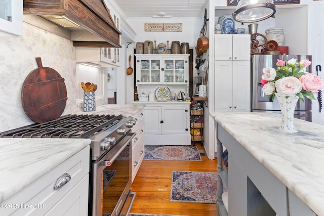 121 Dolphin Ln, Sneads Ferry, NC 28460 - kitchen with stainless steel appliances, white cabinetry, glass insert cabinets, light wood-type flooring, and backsplash