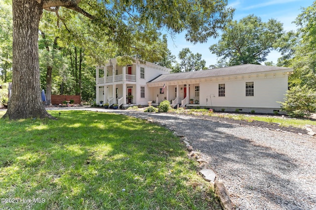 121 Dolphin Ln, Sneads Ferry, NC 28460 - greek revival house with covered porch, a front yard, a balcony, and crawl space