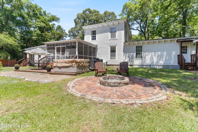 121 Dolphin Ln, Sneads Ferry, NC 28460 - back of house with a sunroom, a patio area, a fire pit, and a lawn