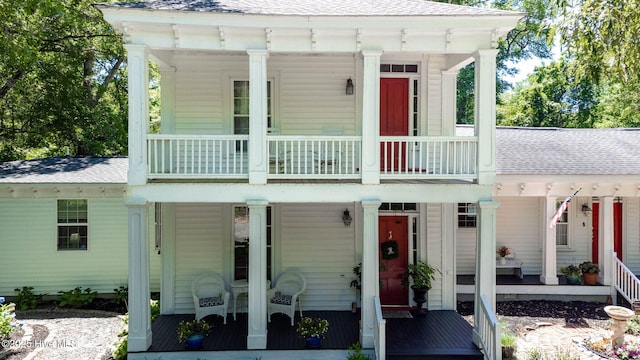 121 Dolphin Ln, Sneads Ferry, NC 28460 - neoclassical home with covered porch, a shingled roof, and a balcony
