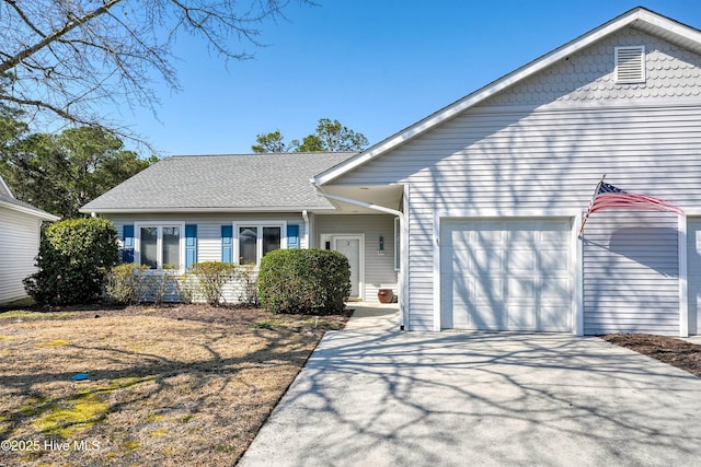 ranch-style house featuring a garage and concrete driveway