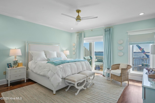 bedroom featuring a ceiling fan, recessed lighting, a view of city, and dark wood finished floors