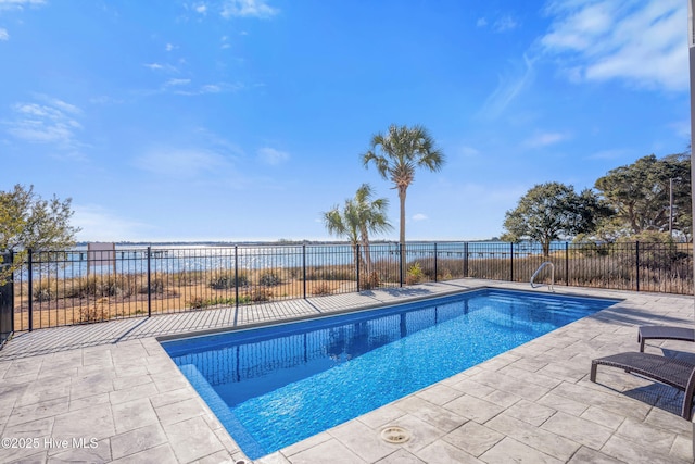 view of pool with fence, a patio area, a water view, and a fenced in pool