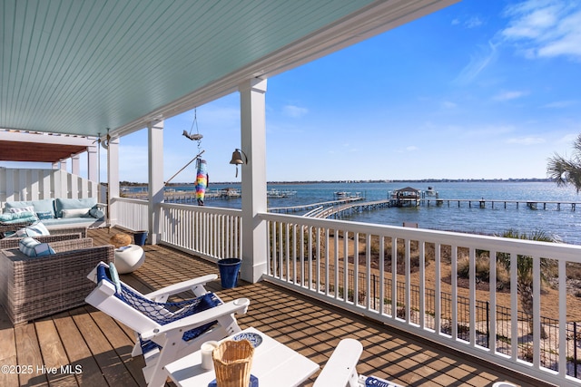 wooden deck featuring an outdoor hangout area and a water view