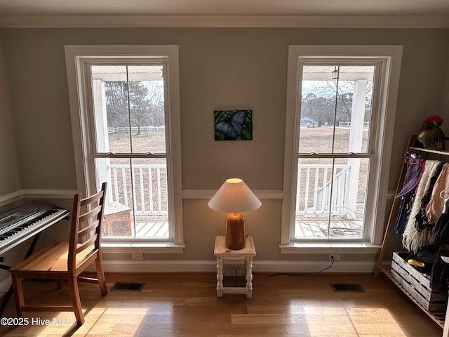 interior space with light hardwood / wood-style flooring and crown molding