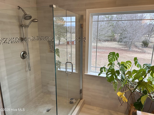 bathroom with a shower with door