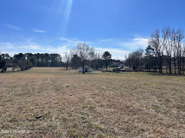 view of yard with a rural view