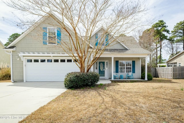 view of front of home featuring fence, driveway, roof with shingles, covered porch, and a garage