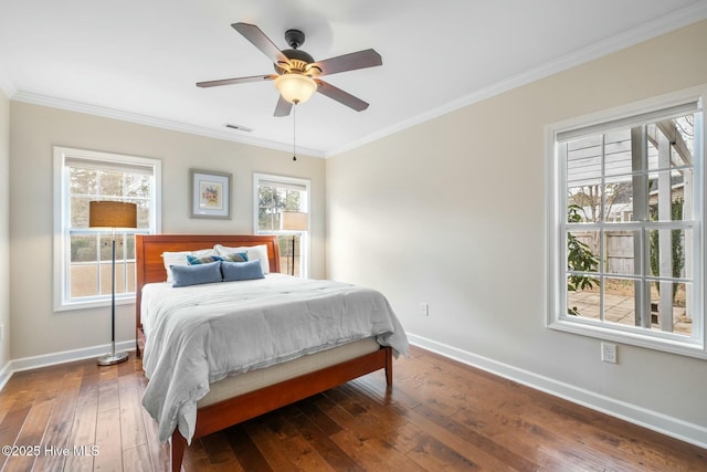 bedroom featuring baseboards, visible vents, wood-type flooring, and ornamental molding