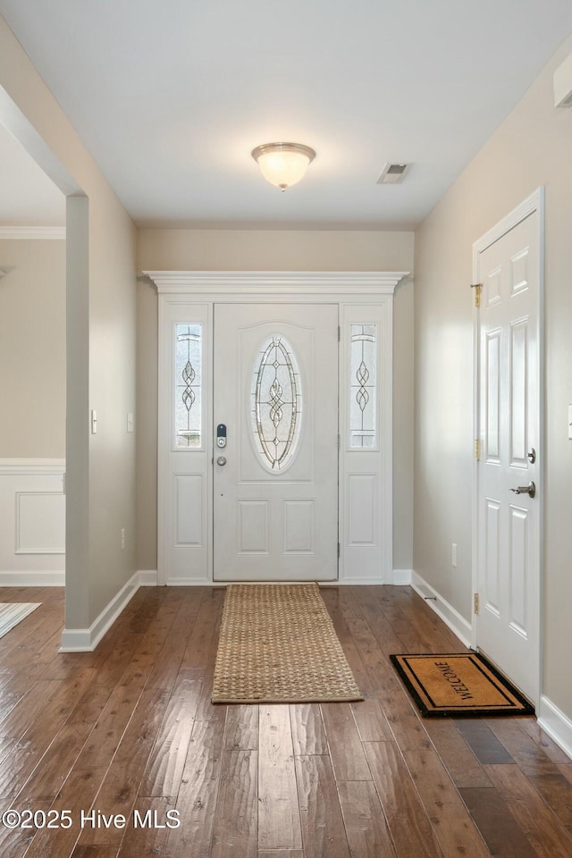 foyer with visible vents, baseboards, and hardwood / wood-style floors