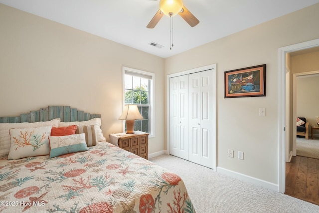 bedroom with visible vents, baseboards, carpet, and a closet