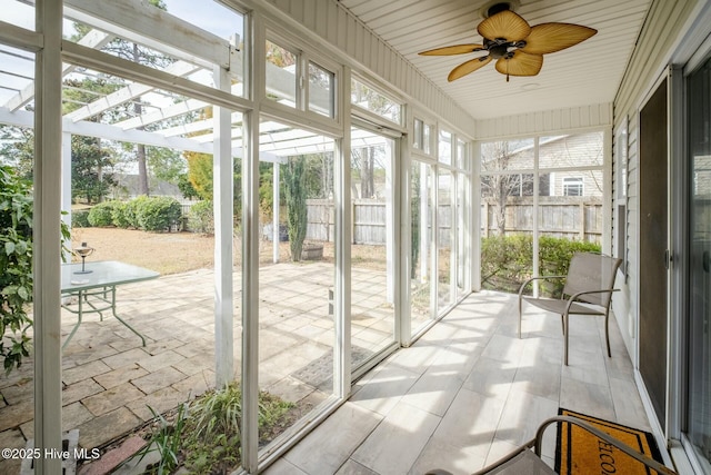 sunroom with a ceiling fan