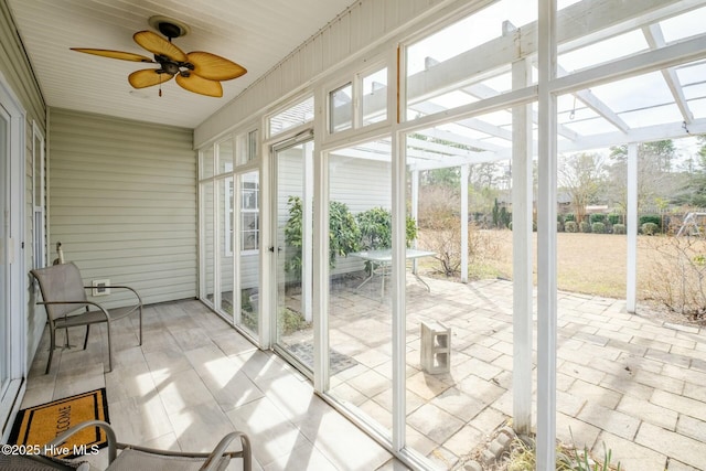 sunroom with a ceiling fan and a healthy amount of sunlight