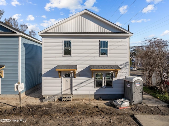 back of property featuring entry steps