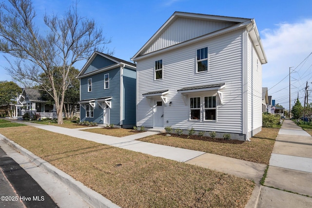 view of front facade featuring board and batten siding and a front yard