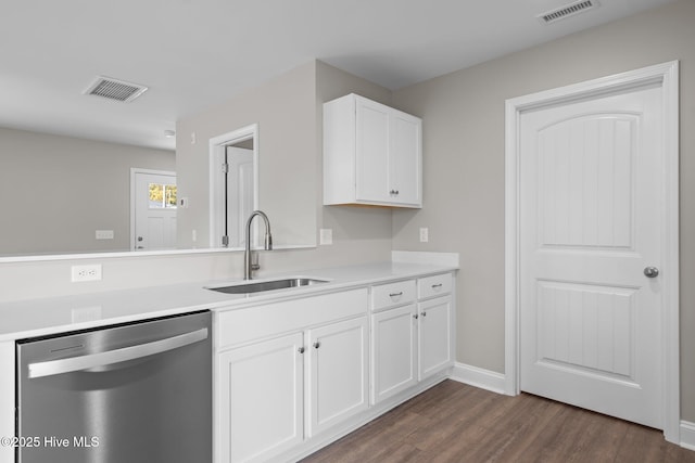 kitchen featuring stainless steel dishwasher, a sink, dark wood-style flooring, and visible vents