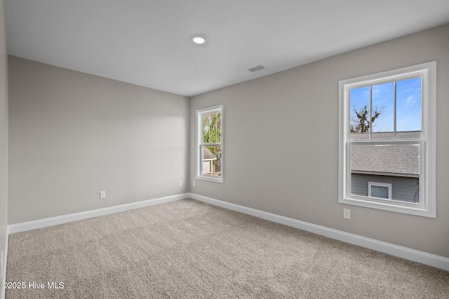 unfurnished room featuring visible vents, recessed lighting, baseboards, and carpet floors