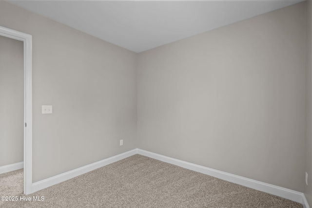 empty room with baseboards and carpet flooring