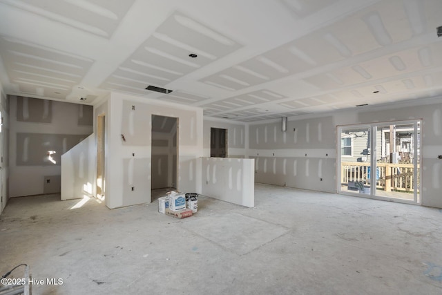 unfurnished living room featuring visible vents