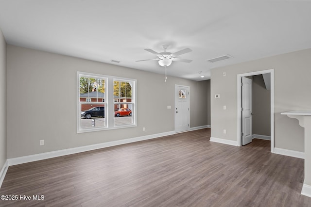 unfurnished living room with a ceiling fan, baseboards, visible vents, and wood finished floors
