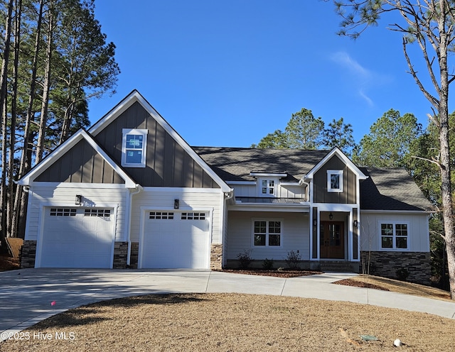 craftsman inspired home featuring driveway, stone siding, and board and batten siding