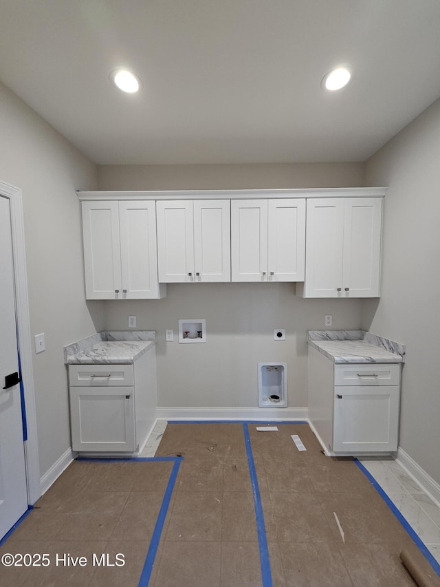 clothes washing area featuring washer hookup, cabinet space, hookup for an electric dryer, and baseboards